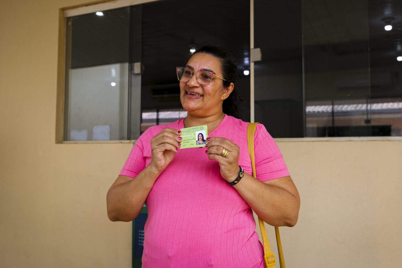 A beneficiada Rosângela Barros comemora a emissão de sua carteirinha